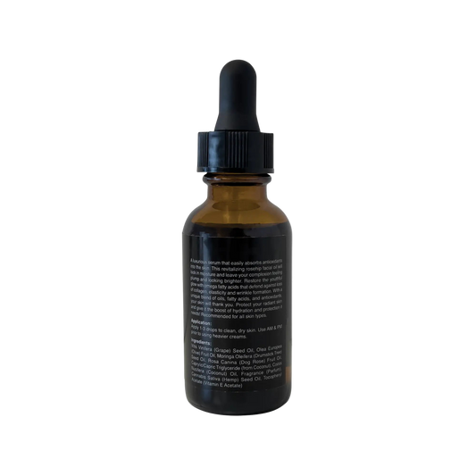 VOUGEA Luxe Rosehip Anti-Aging Serum in glass dropper bottle with rose petals on blush pink background