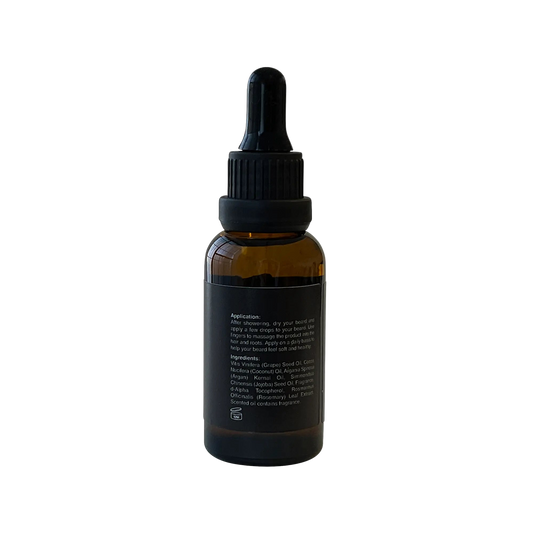 VOUGEA Luxe Premium Beard Oil in amber glass dropper bottle with rosemary sprigs and argan seeds on natural wood background