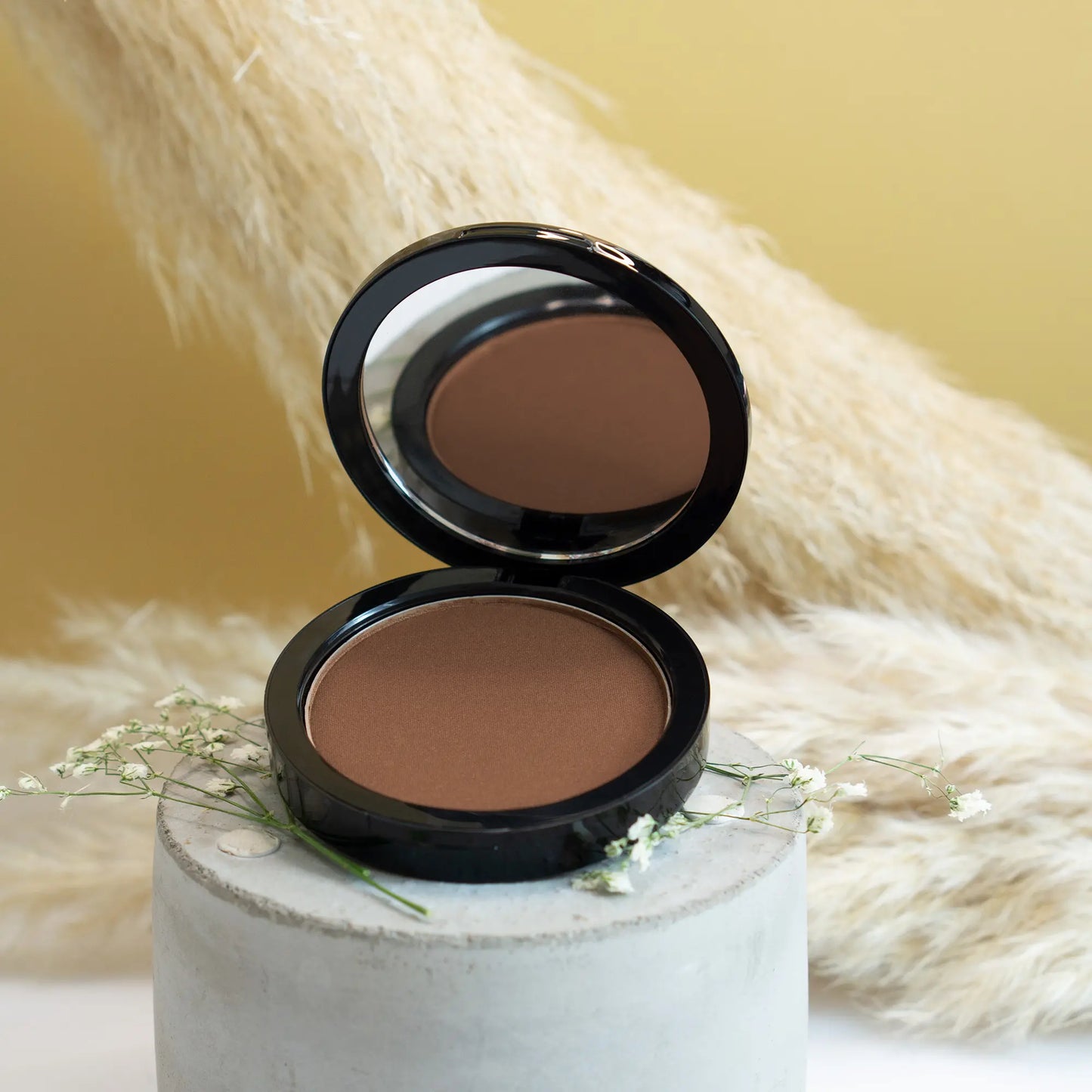 OUGEA Luxe Bronzer powder applied for smooth even coverage”