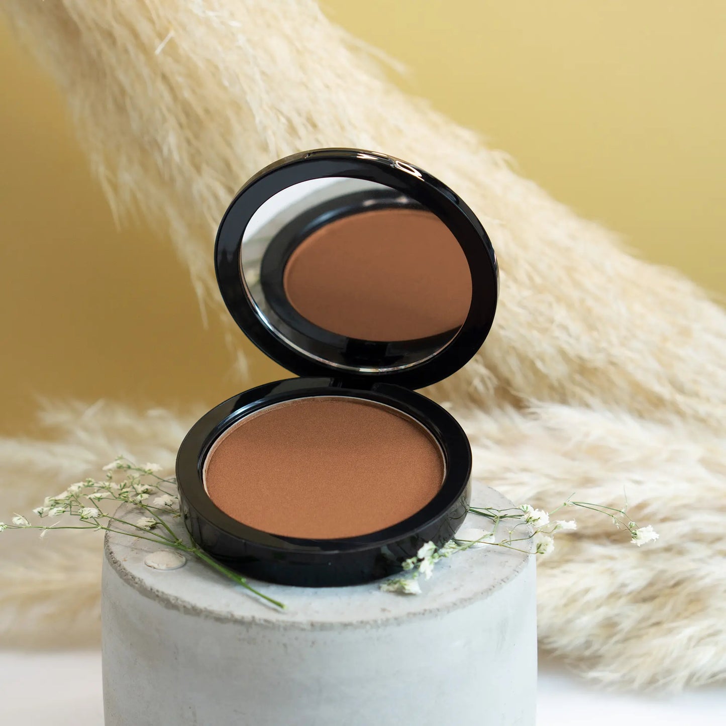 “Balanced red-brown bronzer shade creating sun-kissed skin finish”