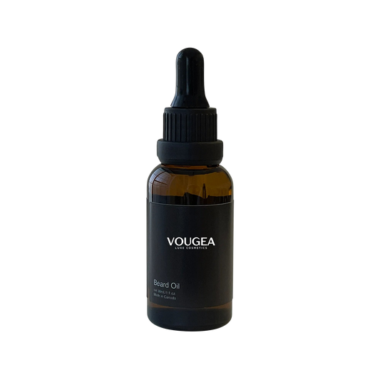 VOUGEA Luxe Premium Beard Oil in amber glass dropper bottle with rosemary sprigs and argan seeds on natural wood background