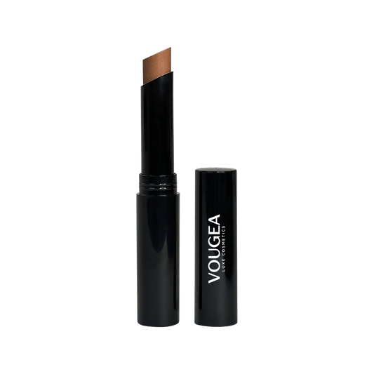 VOUGEA Luxe Crème Concealer Stick in sleek compact tube with creamy matte formula swatched on neutral background